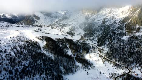 Flying-over-the-alpine-roads-of-the-Italian-Dolomites-on-a-partly-cloudy-day