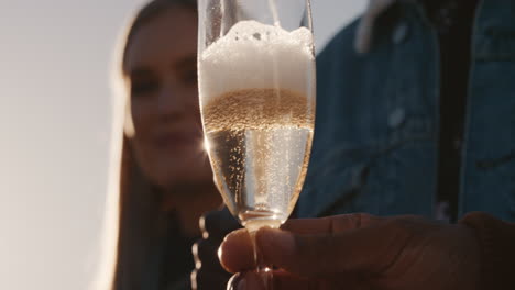 close up young man pouring champagne friends celebrating rooftop party drinking alcohol enjoying reunion celebration