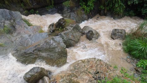 Water-raging-over-the-rocks-of-a-waterfalls-in-the-hills-of-Nepal-during-the-rain-from-a-typhoon