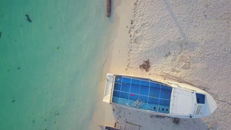 Aerial-flight-along-the-beach-and-crystal-clear-ocean-in-Mabul,-Malaysia