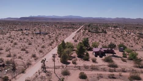 joshua tree california dirt road with houses in desert-2