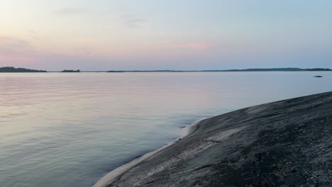 calm water and small waves by a rocky shore