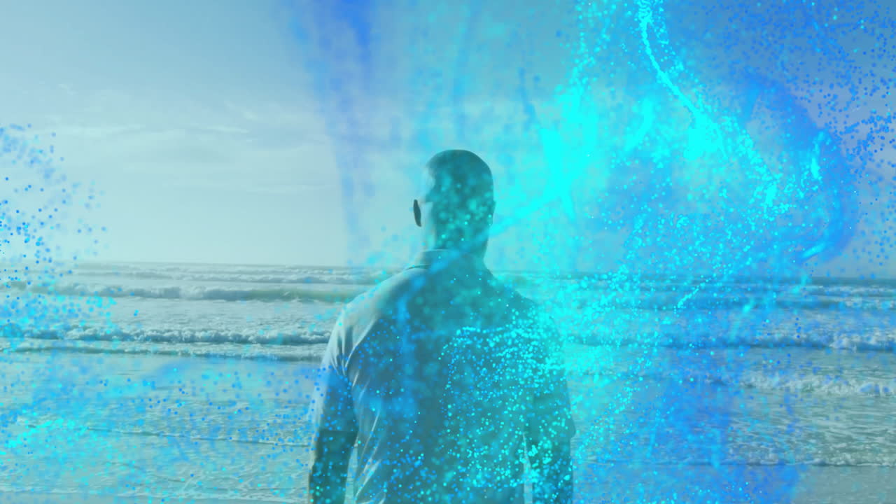 mature man gazing toward ocean horizon, swirling blue digital particles showing technology concept