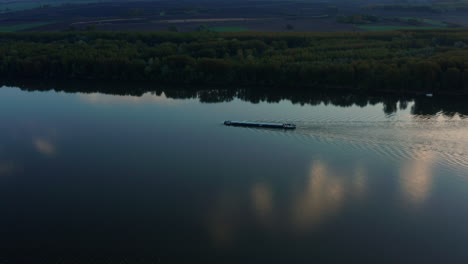 Freighter-Sails-Through-The-Danube-River-With-The-Green-Forest-At-Riverside-In-Croatia