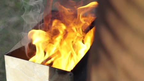 blazing fire heating a branding iron in slow motion, captured in a close-up