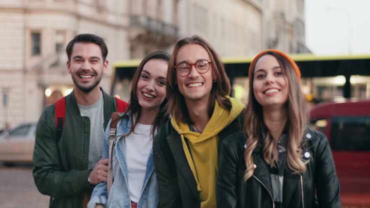 Caucasian group of friends together in the street and smiling at the camera