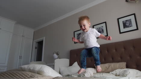 Jumping-off-of-happiness-on-the-bed-looking-at-flying-soap-bubbles