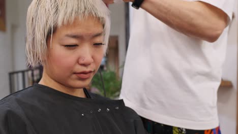 woman getting a haircut in a hair salon