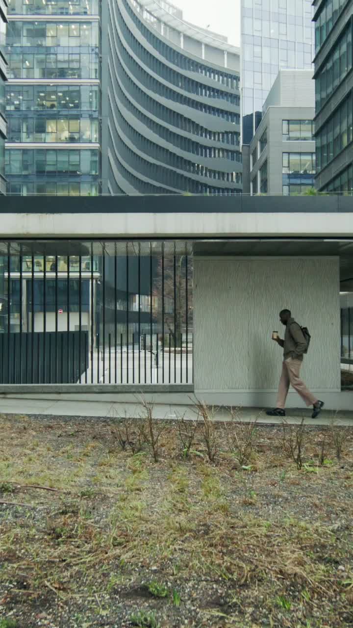 Businessman walking in modern city center