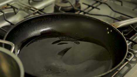 chopped green and white onions sizzling in a black frying pan on a stove