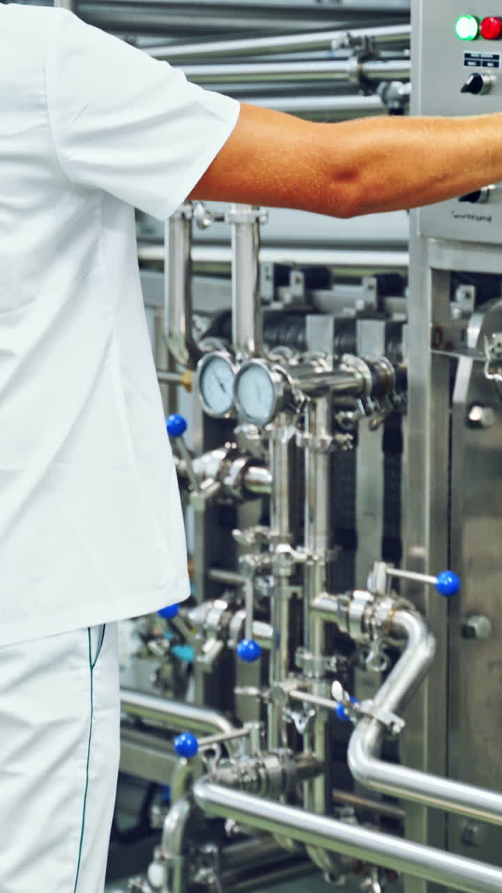 Food processing industry. Equipment for milk production at modern factory Vertical video