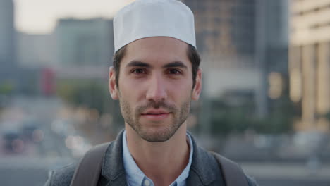 portrait-confident-young-arab-businessman-turns-head-smiling-enjoying-successful-urban-lifestyle-in-city-at-sunset-attractive-muslim-man-wearing-kufi-hat-slow-motion