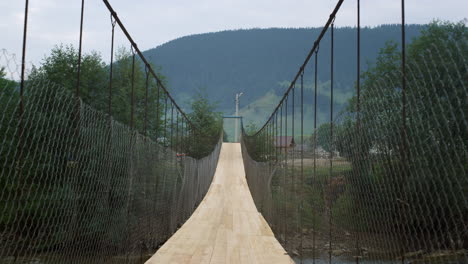 Empty mountains suspension bridge on river nature. Summer landscape no people.