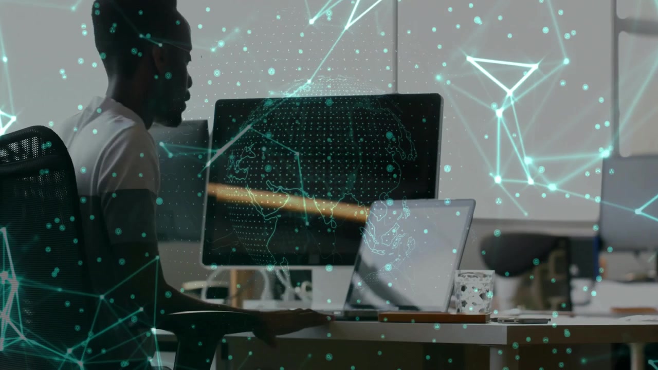 man exploring data analytics in office, with green network overlay showing computer connections