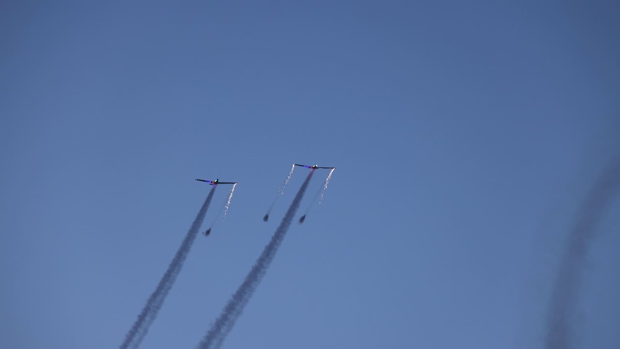tandem pyrotechnic aircrafts starting their display with sparks and fireworks