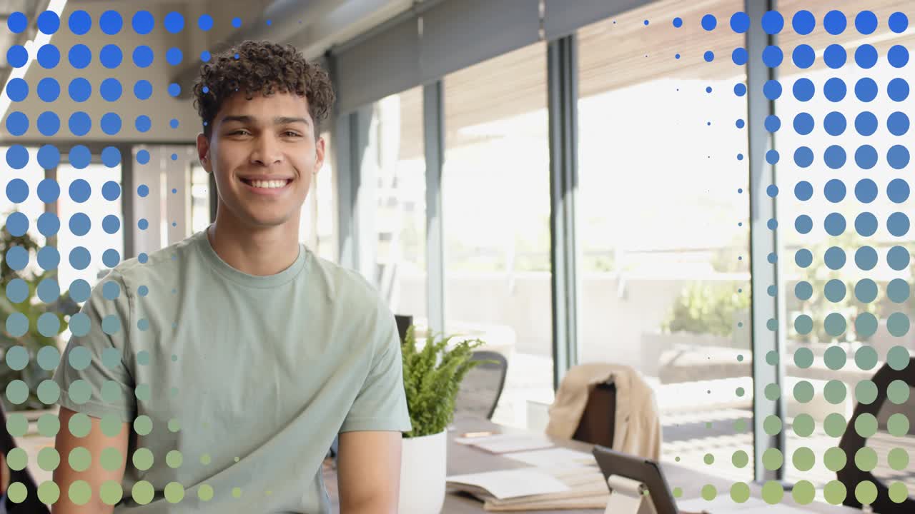 Businessman sitting responding to off-camera prompt, smiling as orange circle appearing over window
