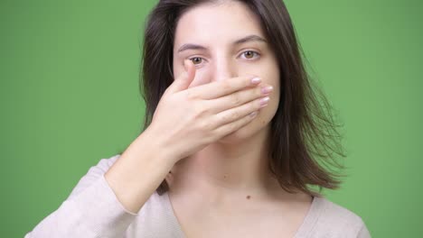 young beautiful woman covering mouth as three wise monkeys concept