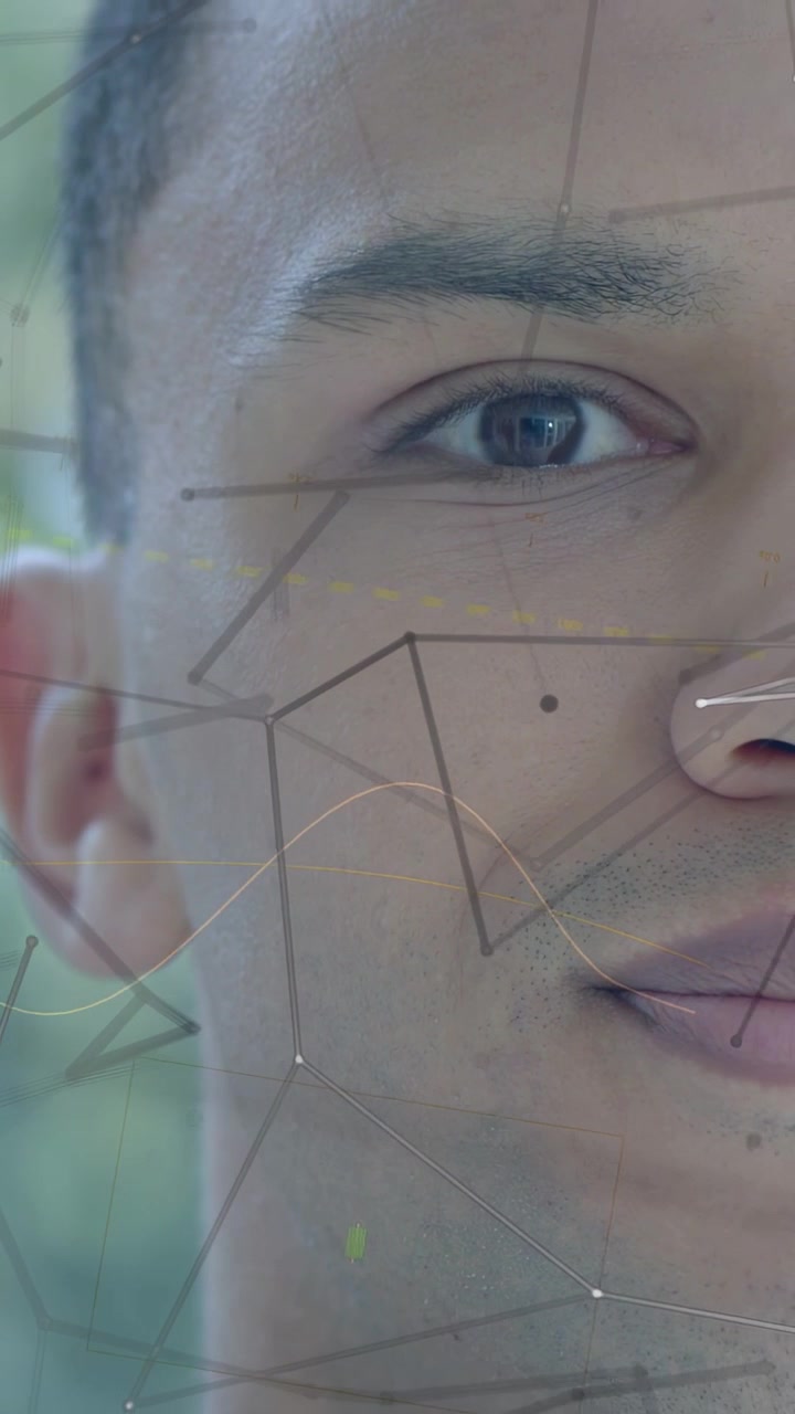 Vertical video: Camera zooming, male face revealing cheek, eye, mole, HUD nodes mapping for tech