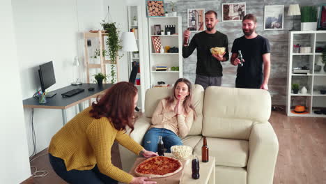 old friends relaxing together watching tv and drinking beer