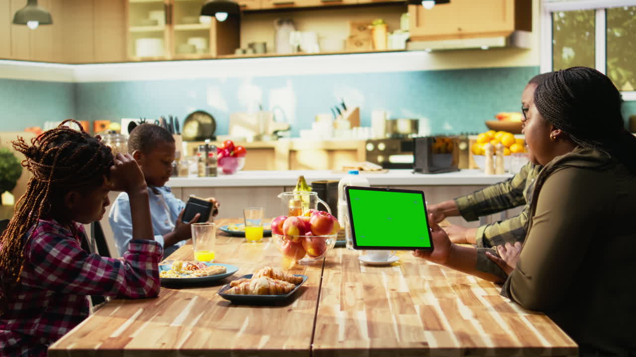 Family having breakfast together in the kitchen