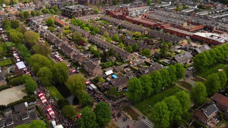 aerial view of people walking in the street with king’s day market in hendrik-ido-ambacht, netherlands