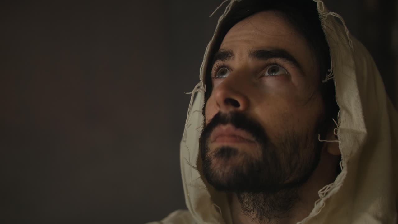 Closeup of the face of Jesus Christ praying in worship in deep contemplation for Christianity, easter, religion stock footage