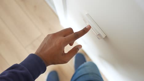 person turning on a light switch