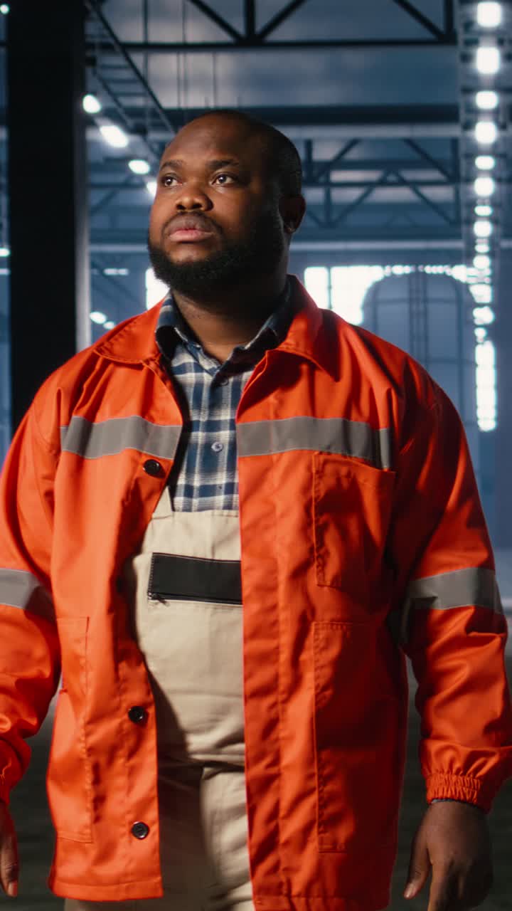 Vertical Video Supervisor walking inside a warehouse to oversee machinery in action