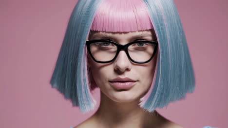 woman with pink and blue hair and glasses