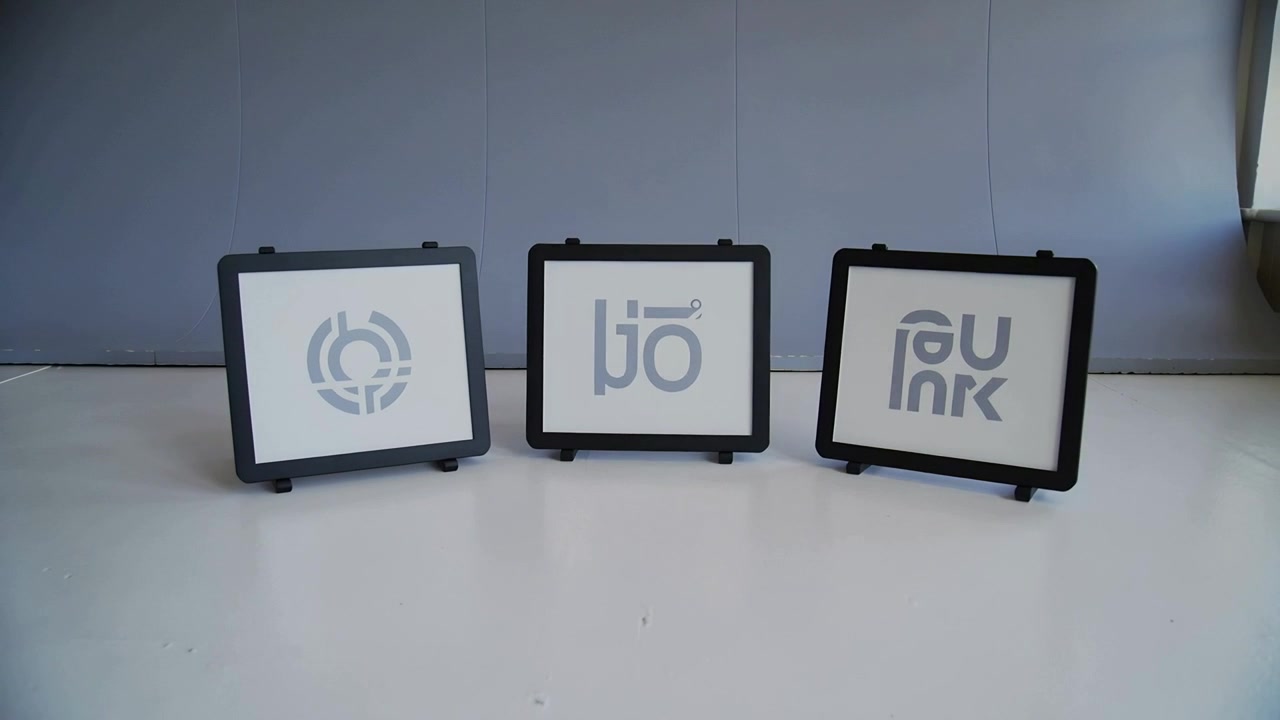 Nudging camera, panning right and pulling back over tabletop, centering three panels, cable visible
