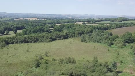 Sky-view-of-road-cutting-through-natural-landscape-in-Woodbury,-England