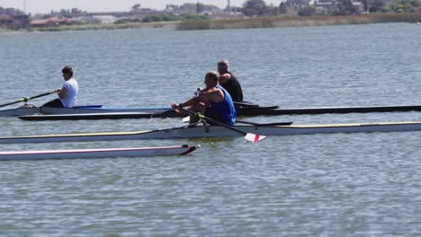 four senior caucasian men and women rowing boat on a river