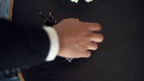 a groom taking a watch off the table, wedding accesories, moders sunglasses, slow motion full hd