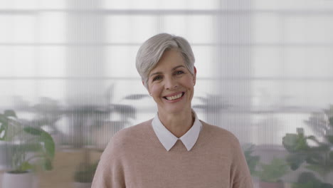 portrait-of-elegant-mature-business-woman-smiling-looking-at-camera-enjoying-successful-lifestyle-senior-female-wearing-jersey-in-office-workspace-background