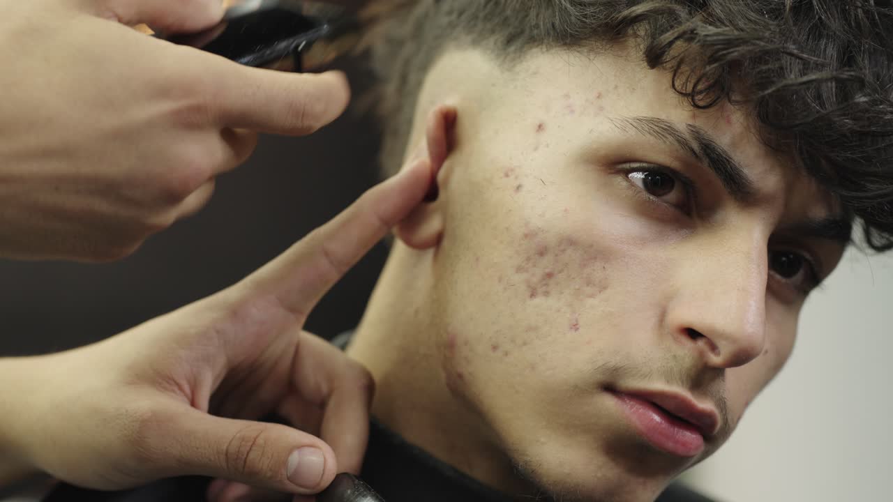 A man getting a haircut at the barber