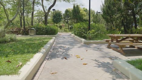 Empty-park-bench-table-with-leaves-fallen-on-the-ground,-no-people-Hong-Kong