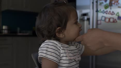 UK-Asian-Baby-Being-Fed-Ice-Cream-Lolly-Whilst-On-High-Chair