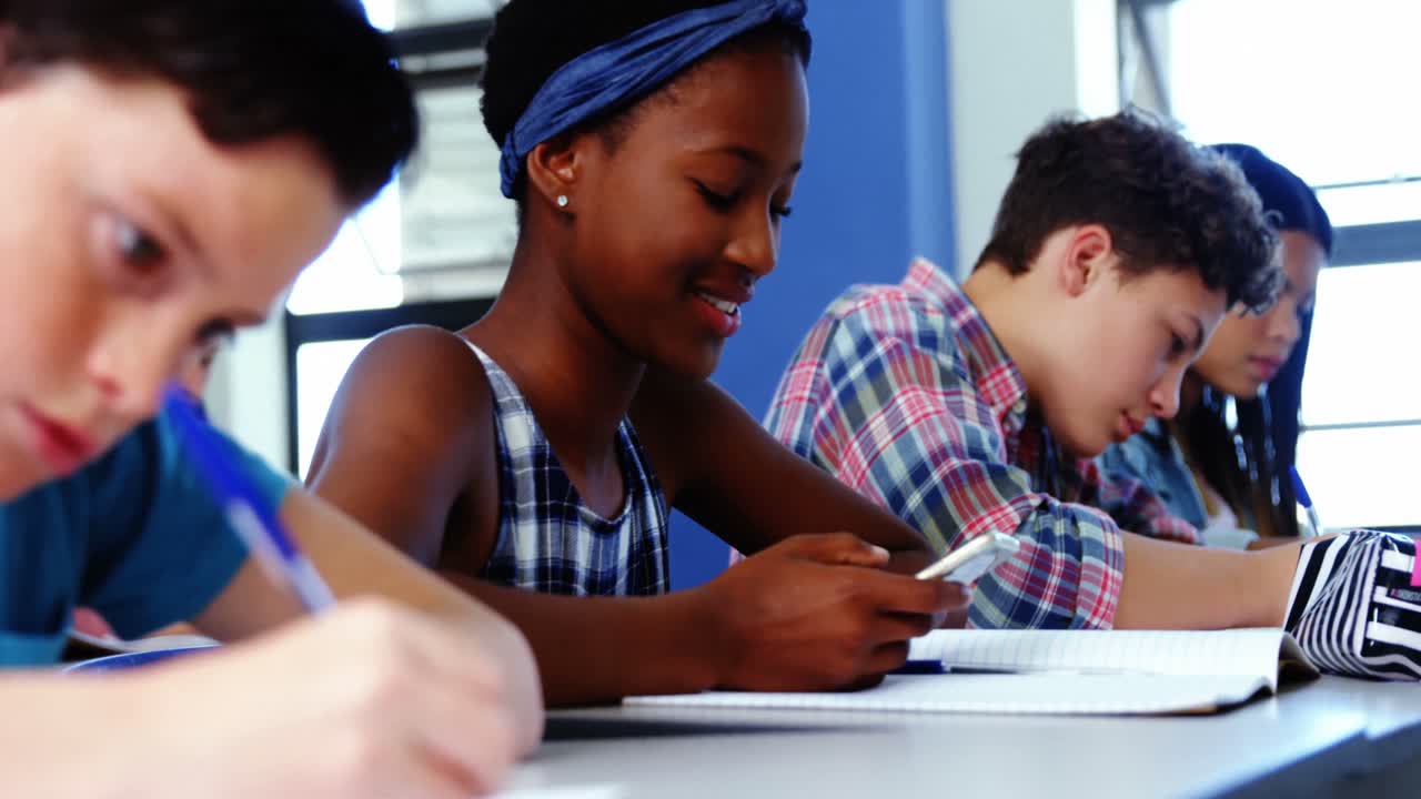 Student using mobile phone in classroom