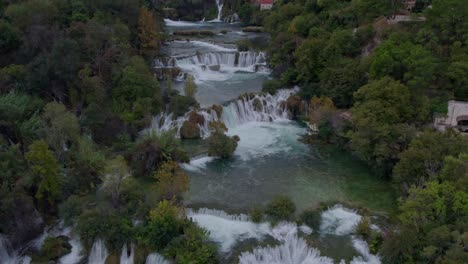 Fly-over-the-famous-Krka-Waterfall-with-no-people-during-sunrise,-arerial