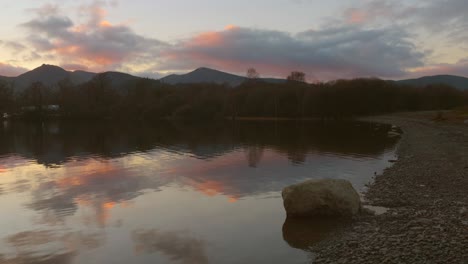 Pan-shot-over-Derwentwater-lake-shore-in-the-English-Lake-District,-Cumbria,-England-at-sunset