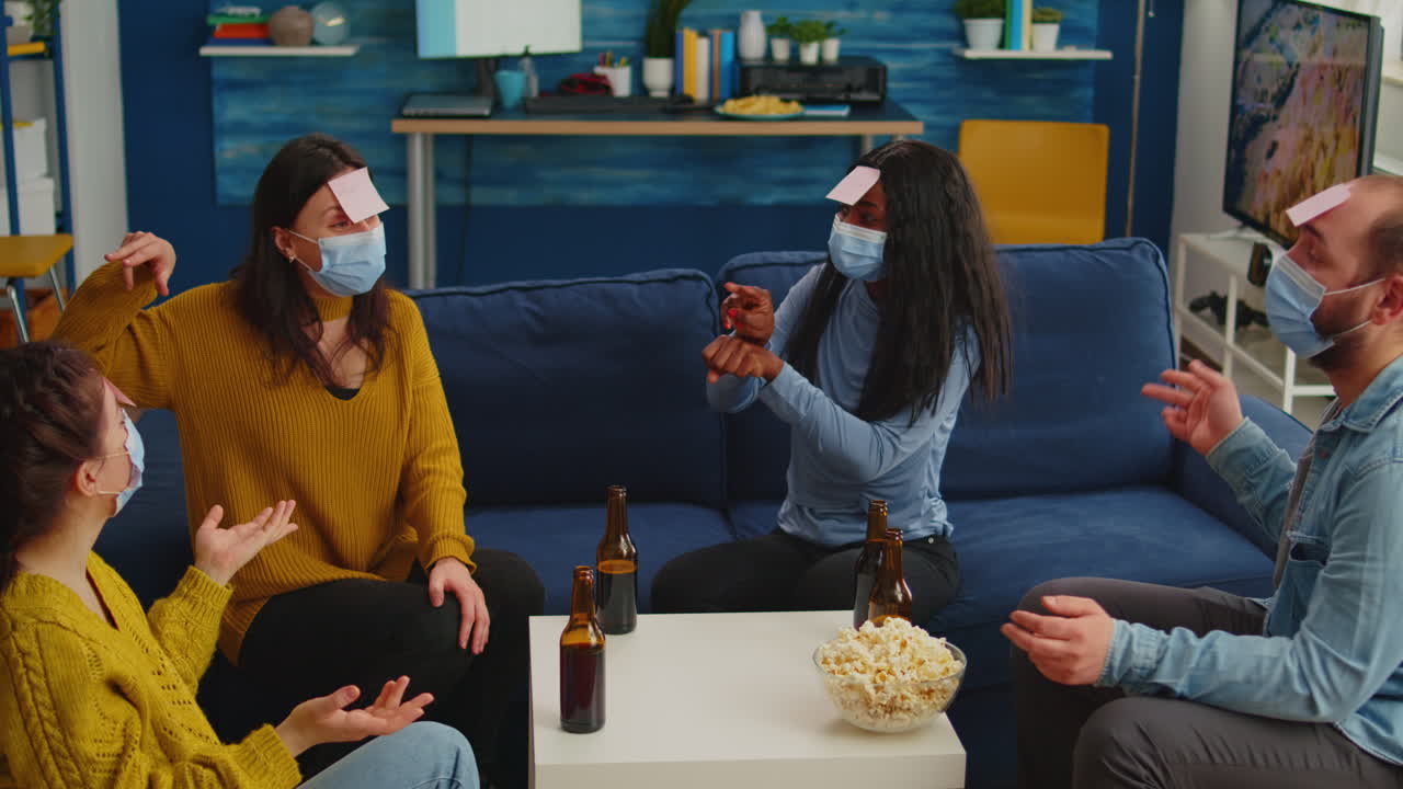 Diverse friends with face mask playing games with sticky notes on forheads