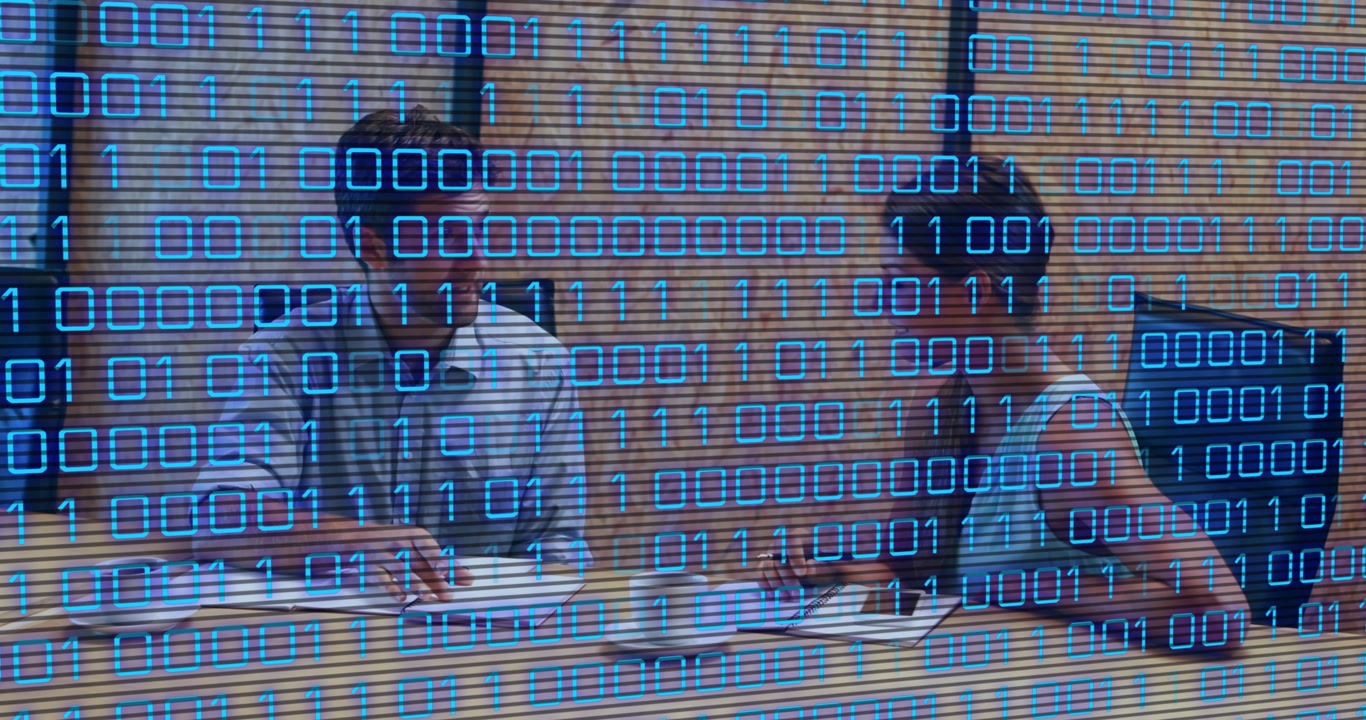 A businessman and woman are sitting in a conference room, discussing something