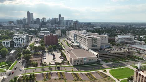 aerial dolly towards saint joseph hospital with skyline of denver in background