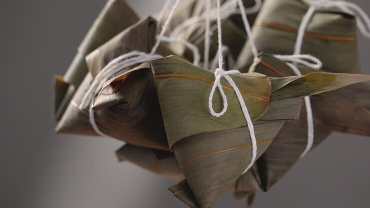 Making zongzi food - preparing and wrapping Chinese rice dumpling.