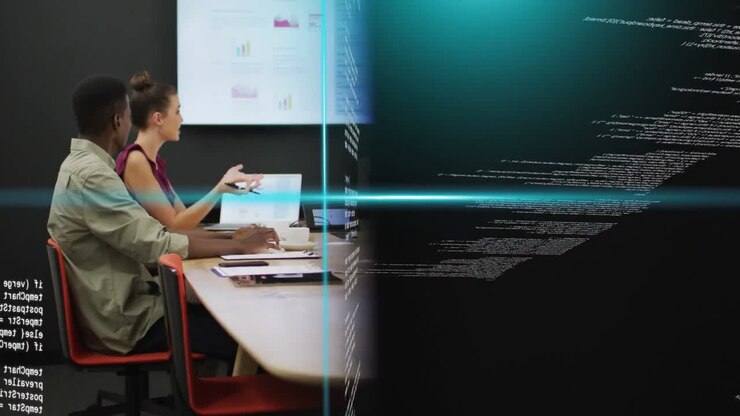 Colleagues gesturing and reviewing charts at business table, code panels shifting to reveal screen