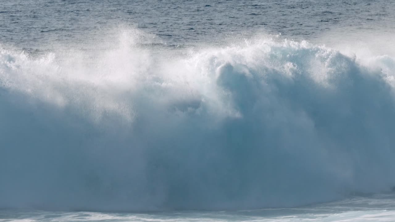 Dramatic ocean waves collide with the volcanic coastline near Timanfaya National Park, located on the island of Lanzarote in the Canary Islands, Spain.