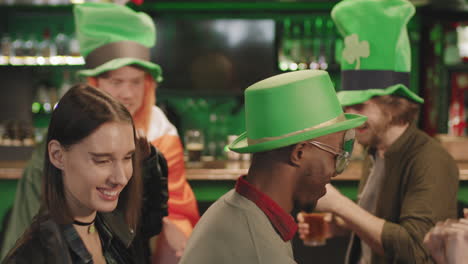 friends dancing in pub on st patricks day