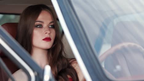 woman driving a classic car