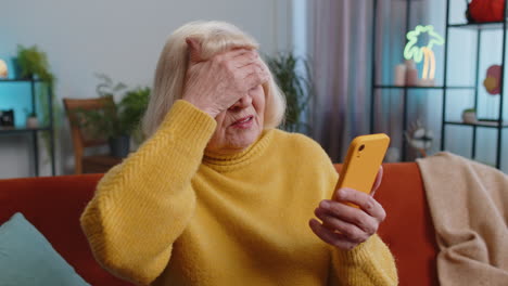 Sad-grandmother-woman-use-smartphone-surprised-by-bad-news-fortune-loss-fail-lottery-result-deadline