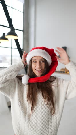 woman wearing santa hat in modern home